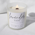 Picture of a candle burning with a label that says "Lavender Tide" along with the fragrance notes of lavender, eucalyptus, sage, and cedar