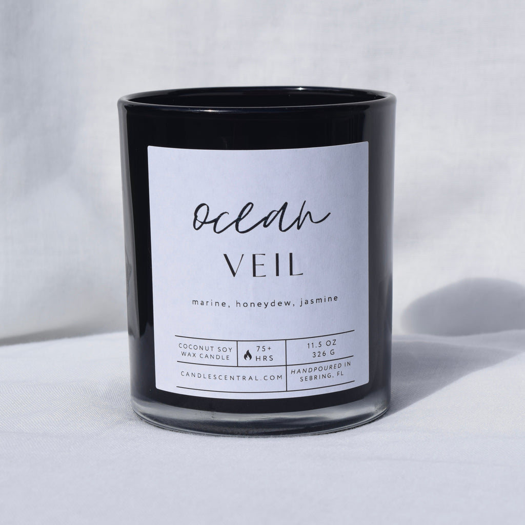 Picture of a candle with a label that says "Ocean Veil" along with the fragrance notes of marine, honeydew, and jasmine