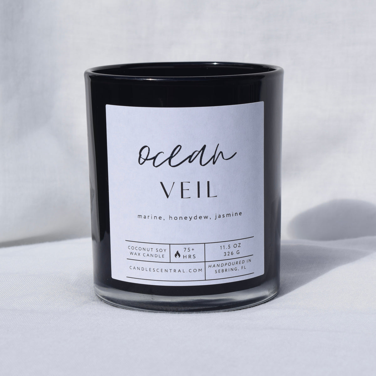 Picture of a candle with a label that says "Ocean Veil" along with the fragrance notes of marine, honeydew, and jasmine