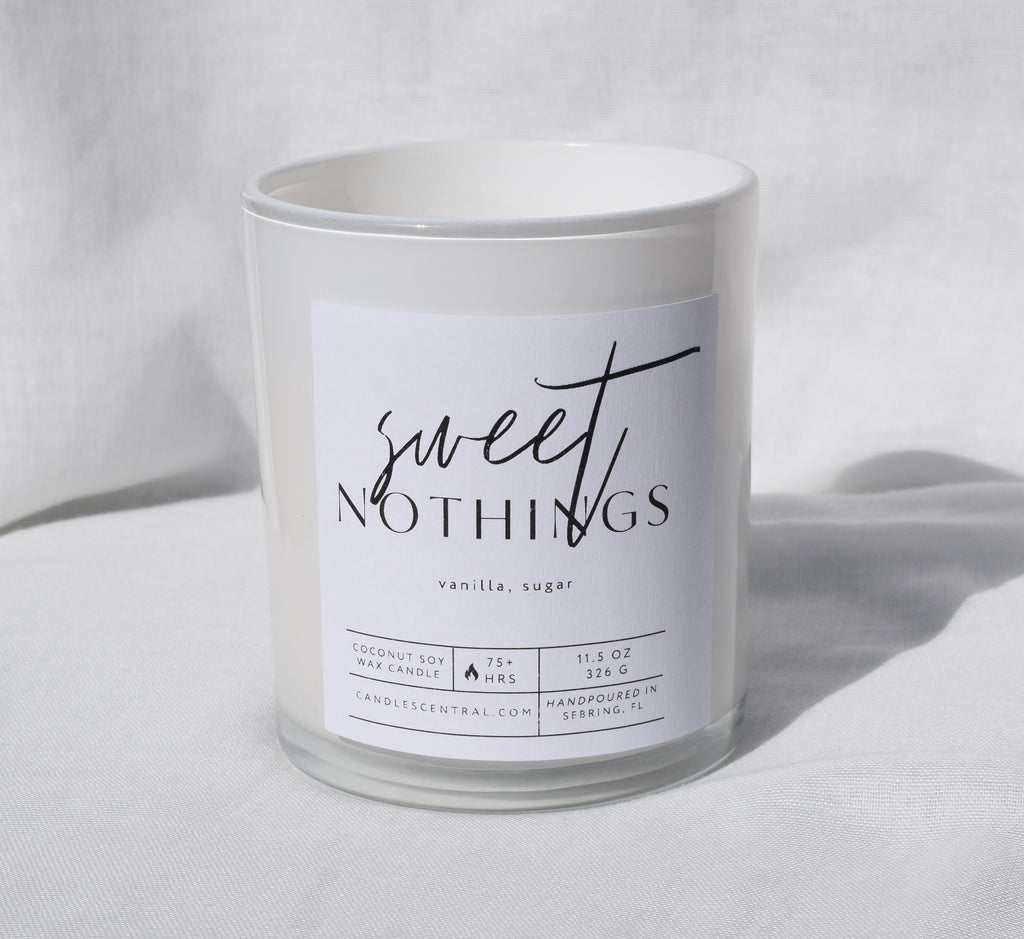 Picture of a candle with a label that says "Sweet Nothings" along with the fragrance notes of vanilla and sugar